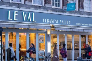 Front of Le Val's restaurant with people walking