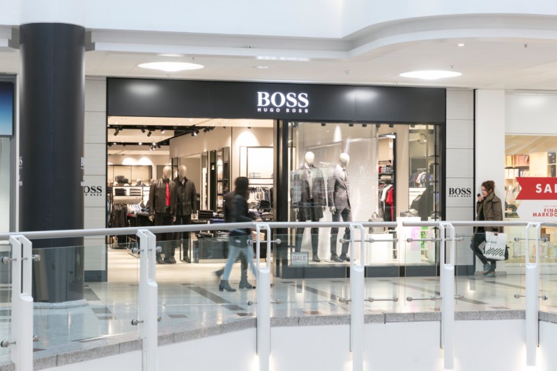Shop front with clothes visible through the window.