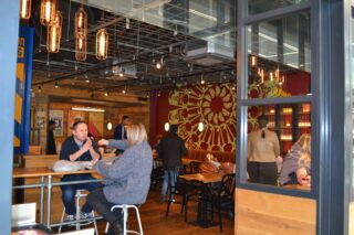 Photo inside Tortilla with customers sitting down and warm lighting