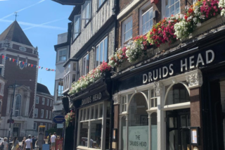 Front of Druids Head pub with tables and chairs outside