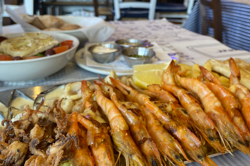 A platter of fried squid and king prawns  at a restaurant. 